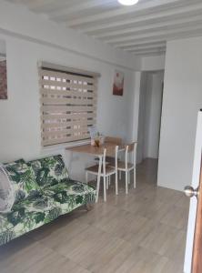 a living room with a couch and a table at DVM Transient Inn by RedDoorz in Santo Tomas