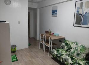 a living room with a couch and a table at DVM Transient Inn by RedDoorz in Santo Tomas