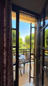 a room with a balcony with a table and a view at Despo Hotel in Gouves