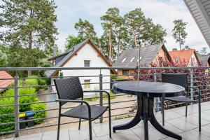 a patio with a table and chairs on a balcony at Haus 44 in Röbel