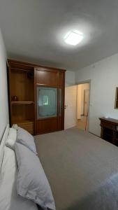 a bedroom with a large bed and a television at Ca' di Miglietto in Varigotti