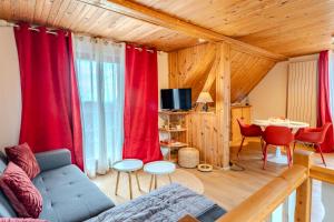 a living room with red curtains and a couch at RIESLING - Vue imprenable sur le vignoble - rénové récemment - parking gratuit in Riquewihr