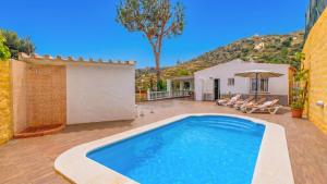 a swimming pool in the backyard of a house at Elsa Torrox by Ruralidays in Torrox