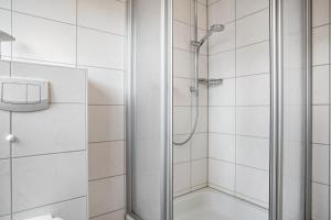 a shower with a glass door in a bathroom at Haus 44 in Röbel +42 photos