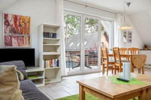 a living room with a table and a dining room at Haus 44 in Röbel