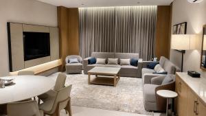 a living room with a couch and a table at Anisa Residence in Salalah