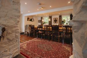 a dining room with a table and chairs at Cwmalis Hall in Llangollen