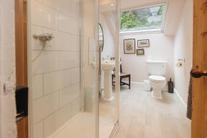 a bathroom with a shower and a toilet at Cwmalis Hall in Llangollen +45 photos