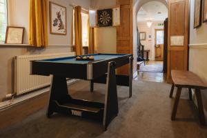 a living room with a pool table in it at Cwmalis Hall in Llangollen
