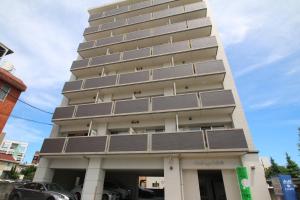 a tall building with solar panels on it at オンブラージュ九品寺203-無料駐車場付き-繁華街まで徒歩圏内-南向きで明るいワンルーム in Kumamoto