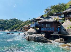 a row of houses on the side of a river at OK Bungalow in Ko Tao
