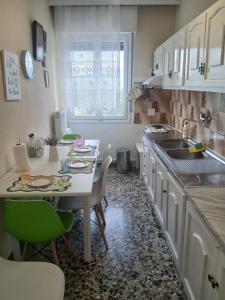 a kitchen with a table and chairs and a sink at Chrysafenia's House in Mandrákion
