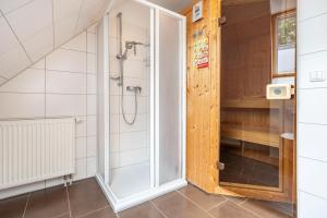 a shower with a glass door in a bathroom at Haus K 104 in Röbel +45 photos