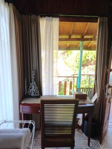 a room with a desk and a table and a window at Aramaya Hills Boutique in Banjar