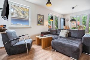 a living room with a couch and a chair at Haus K 104 in Röbel
