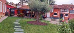 a tree in the yard of a house at hôtel La scuderia in Pont-de-Chéruy