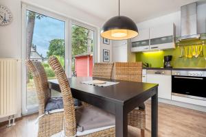 a kitchen with a black dining table and chairs at Haus K 104 in Röbel