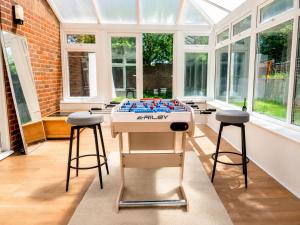 a game table in a conservatory with stools at iblets in Gravesend