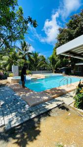 a person standing next to a swimming pool at MacCreek in Macrohon
