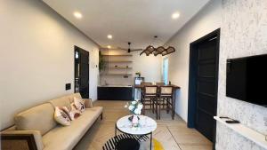 a living room with a couch and a table at Calangute Heights in Calangute