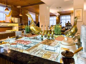 a buffet line with different types of food on display at Hotel Zamek Gniew in Gniew
