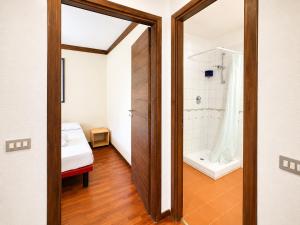 a bathroom with a shower and a bath tub at Hostdomus - B4-03 in Grange Sises +7 photos