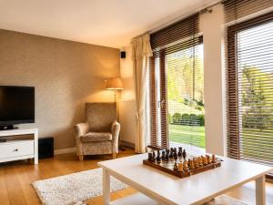 a living room with a chess board on a table at Dom Wakacyjny Brenna in Brenna