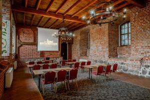 a room with tables and chairs and a projection screen at Hotel Zamek Gniew in Gniew +105 photos