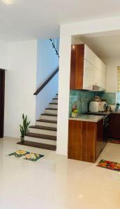 a kitchen and a staircase in a house at Prime Lake Villa in Kundasale