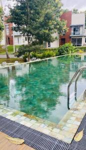a swimming pool with blue water in front of a building at Prime Lake Villa in Kundasale