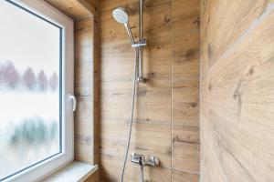 a shower in a bathroom with a wooden wall at Yellow in Miltenberg +111 photos