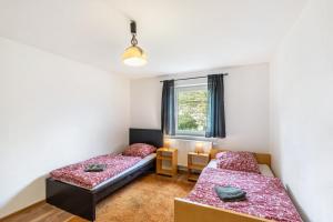 a bedroom with two beds and a window at Yellow in Miltenberg