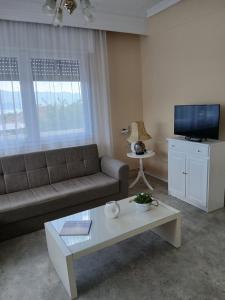 a living room with a couch and a coffee table at Chrysafenia's House in Mandrákion