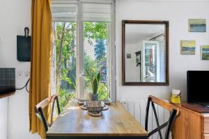 a dining room with a table and a window at Le Petit Bécot De Paimpol in Paimpol +22 photos