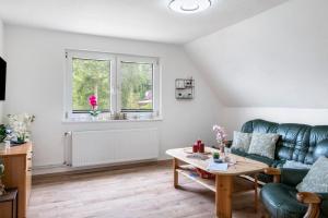 a living room with a couch and a table at Tanne in Sprakensehl