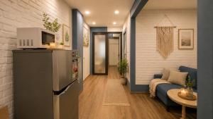 a living room with a refrigerator and a couch at JOY APARTMENT TAY HO in Hanoi