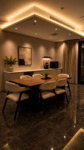 a dining room with a wooden table and chairs at فندق أروف Aroov Hotel in Taif