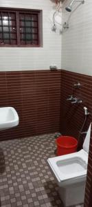 a bathroom with a sink and a toilet and a tub at Hotel Suncity Villa in Trivandrum