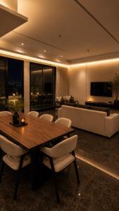 a living room with a table and chairs and a couch at فندق أروف Aroov Hotel in Taif