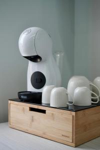 a mixer sitting on top of a wooden stand with dishes at Tra 2 Blu Guest House in Belvedere Marittimo