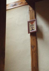 a wooden cross on the side of a wall at YADOease in Tsuiki