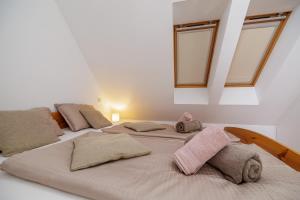a group of three beds in a room with windows at Holiday Home Katja in Srpenica