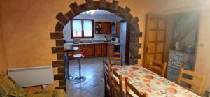 a kitchen and dining room with a table and a counter at House surrounded by creek in La Bresse