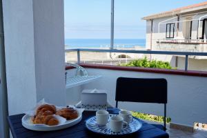 a table with two plates of pastries on a balcony at Tra 2 Blu Guest House in Belvedere Marittimo
