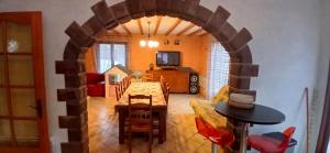 a living room with a table and a dining room at House surrounded by creek in La Bresse