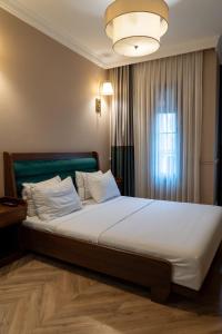 a large bed in a room with a window at D-orients in Istanbul