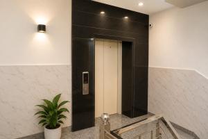 a black and white elevator in a building at Hotel IT Park Home Stay Near DLF City Centre Mall in Manī Mājra +17 photos