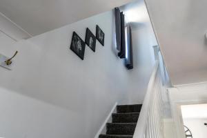 a staircase in a house with three pictures on the wall at iblets in Gravesend +16 photos