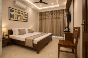 a bedroom with a bed and a television in it at Hotel IT Park Home Stay Near DLF City Centre Mall in Manī Mājra