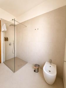 a bathroom with a shower and a toilet and a sink at Giuditta Apartment in Ciriè
